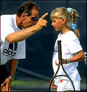 Tennis Coach Nick Bollettieri gives instructions to a young Anna Kournikova.